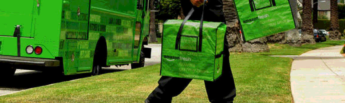 A man is delivering AmazonFresh goods to a house