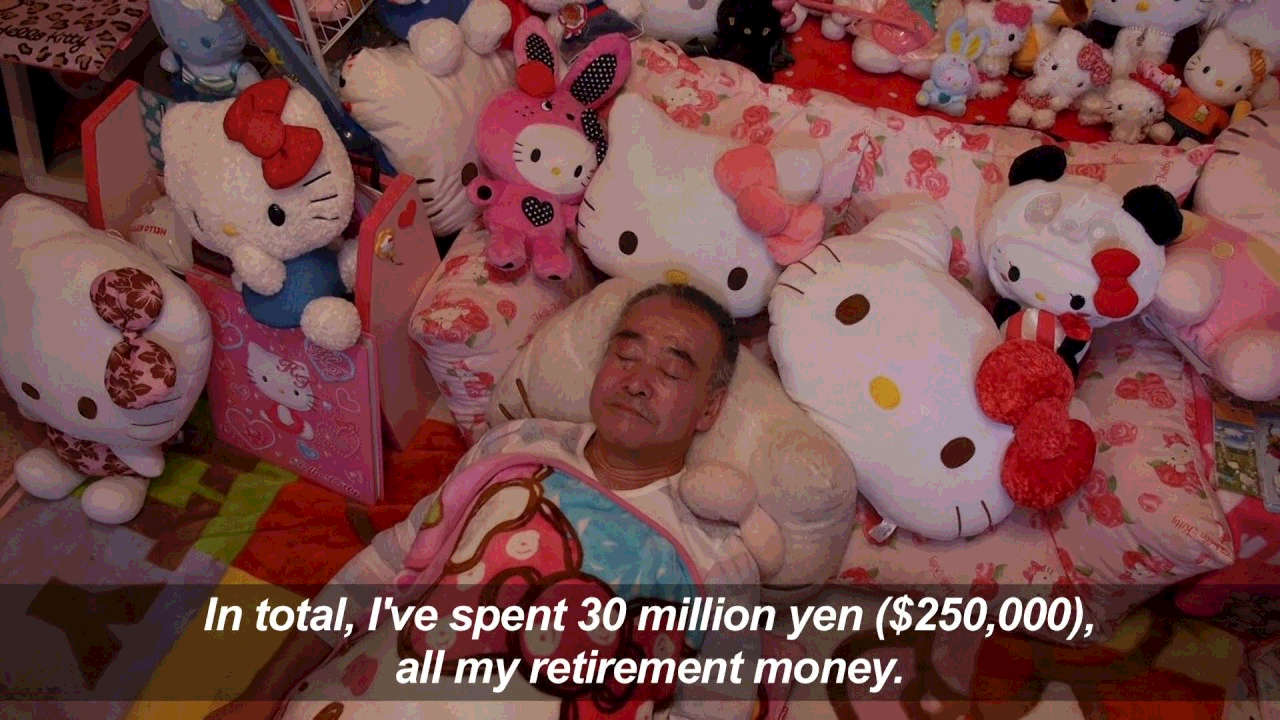 A man laying bed who spent his retirement money on Hello Kitty merchandise