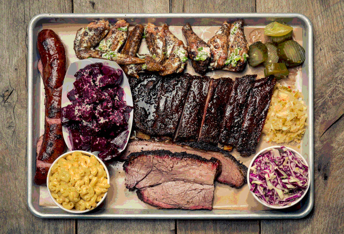 A sample platter of slow cooked, smoked, and barbequed meats, vegetables, and sides