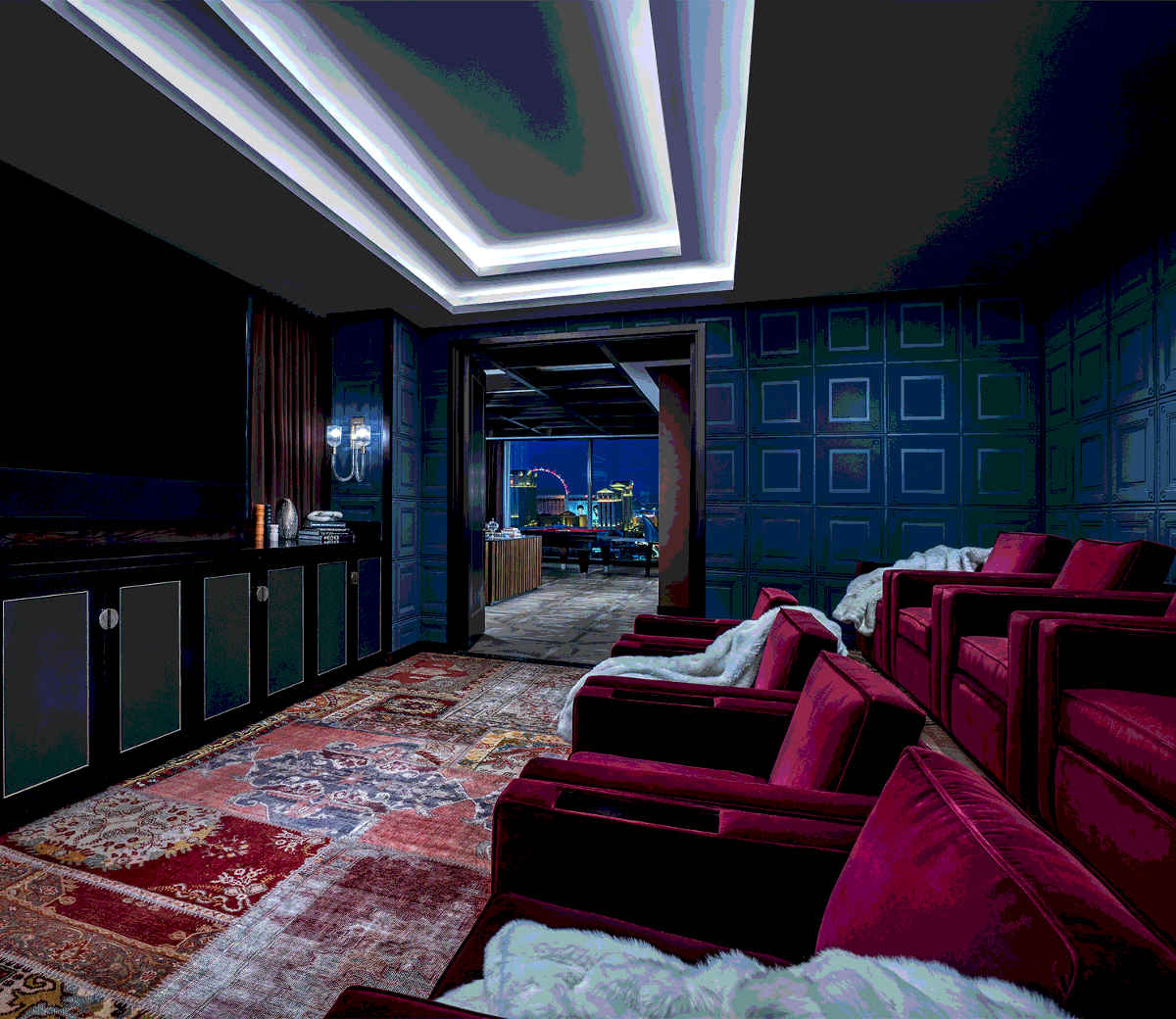 Two banks of plush chairs face the screen in this movie room