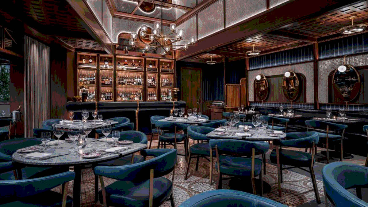 The intimate indoor seating area like a Speakeasy but for fine food, with tiled floor, smart blue chairs, and a private bar