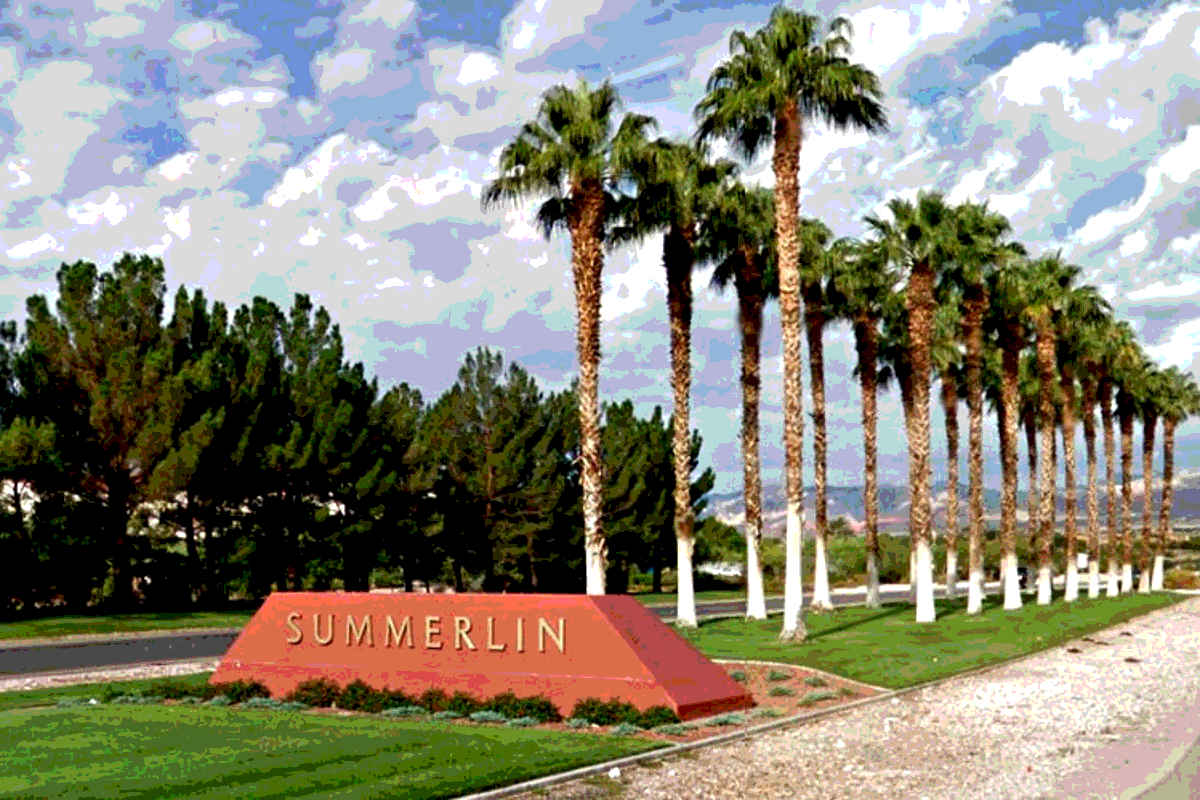 The entrance monument for Summerlin, Nevada, approaching from the east, with rows of palm trees.