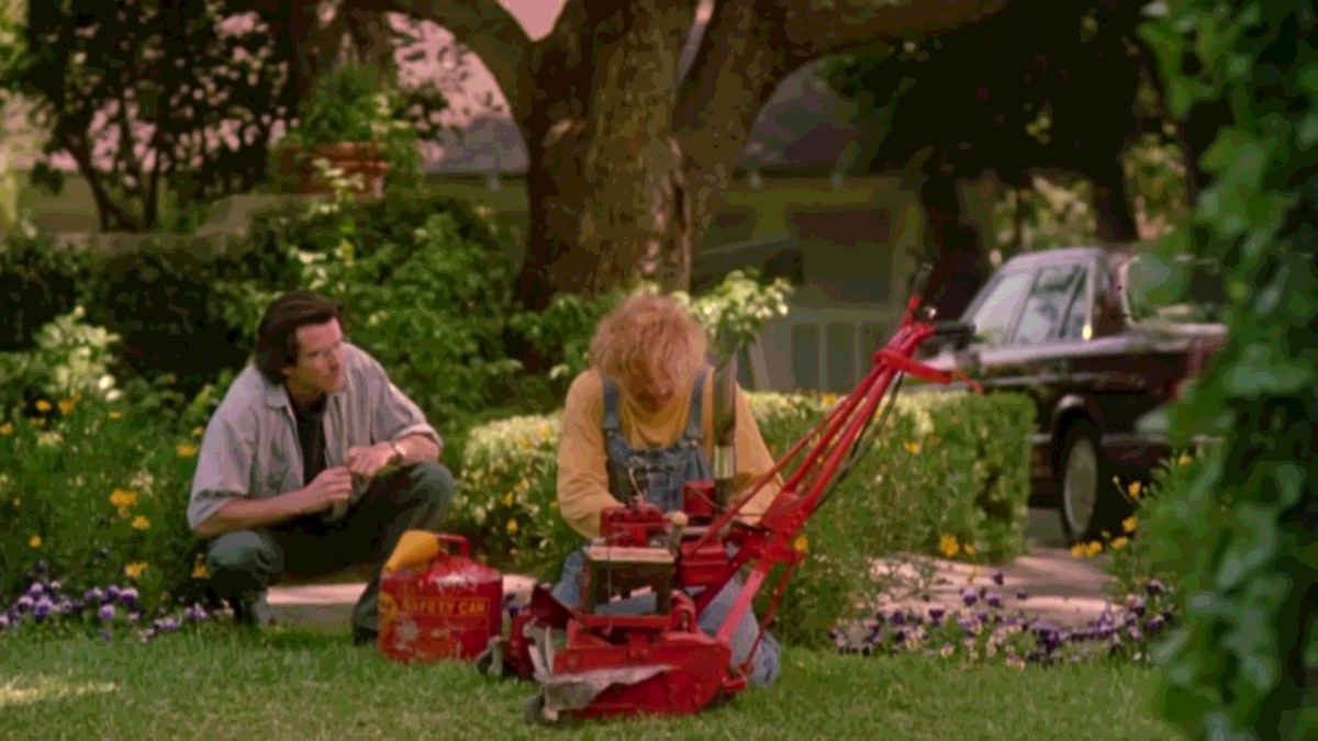 A doctor talks to a lawnmower man who is fixing his lawnmower