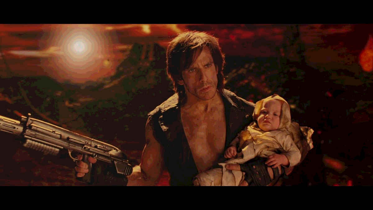 Tugg Speedman, holding a weapon and a baby, in a world on fire, stars in one of the Scorcher movies in Tropic Thunder (2008)